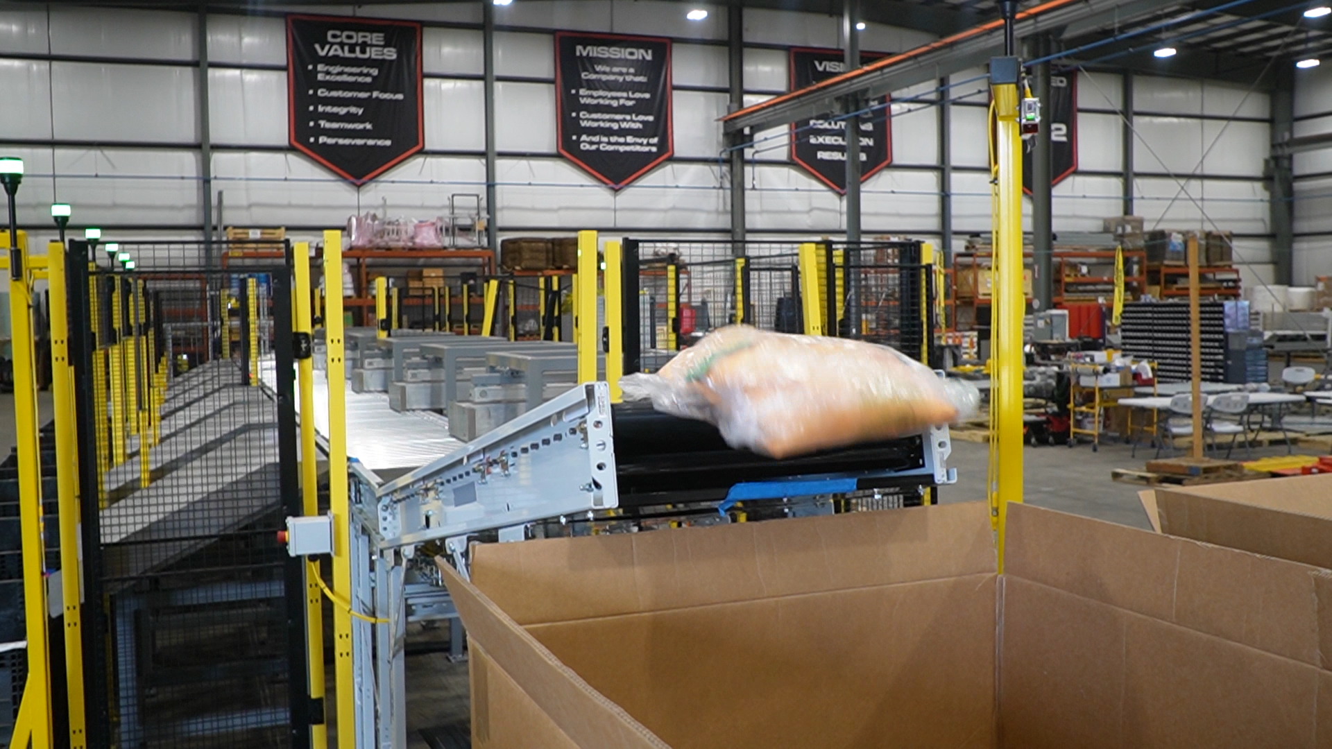 Exception package being diverted to an alternate container at the end of the automated sortation line