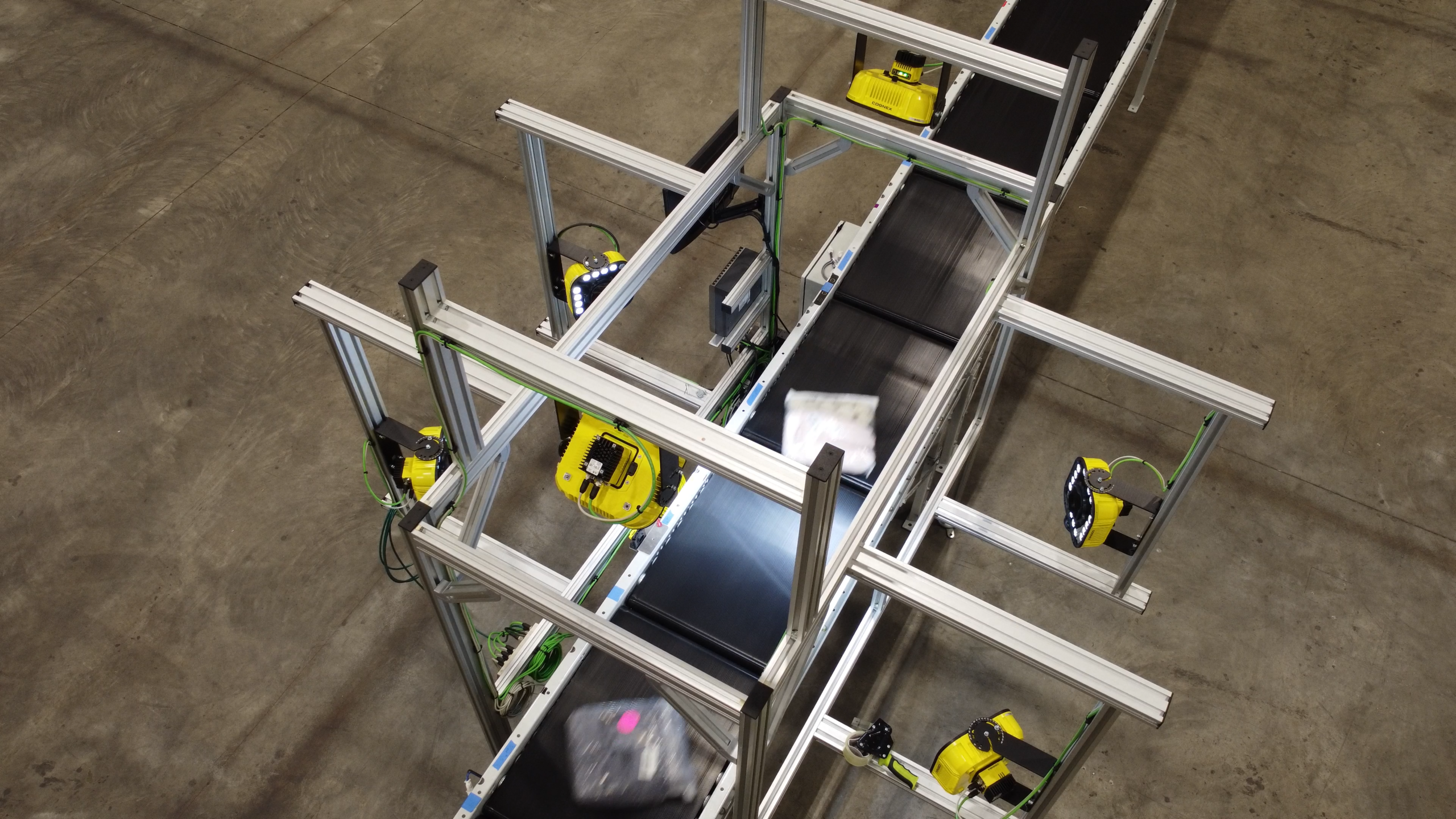 Autotec multi-camera barcode scan tunnel identifying packages before automated sortation