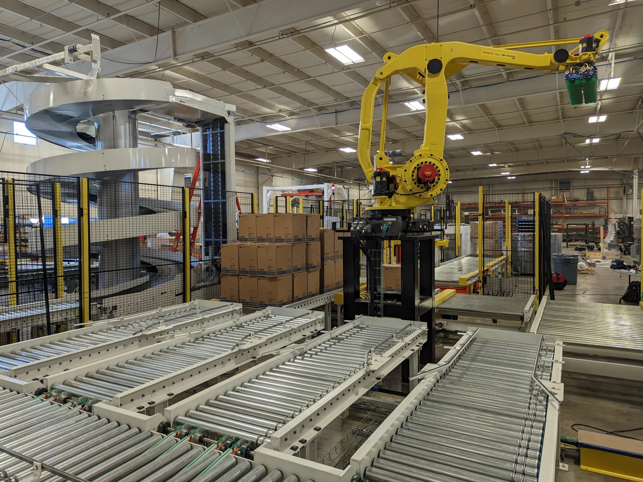 Autotec Solutions warehouse automated material handling and packaging system for robotic pallet moving, case erecting, and palletization.