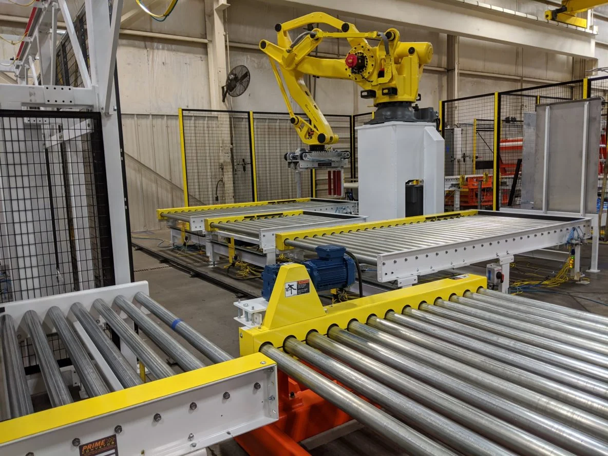 Autotec Solutions’ robotic automation transfer cart, this rail guided vehicle is part of a larger manufacturing and material handling system. The customer-specified end-of-arm tool is designed for roll handling and palletizing operations.